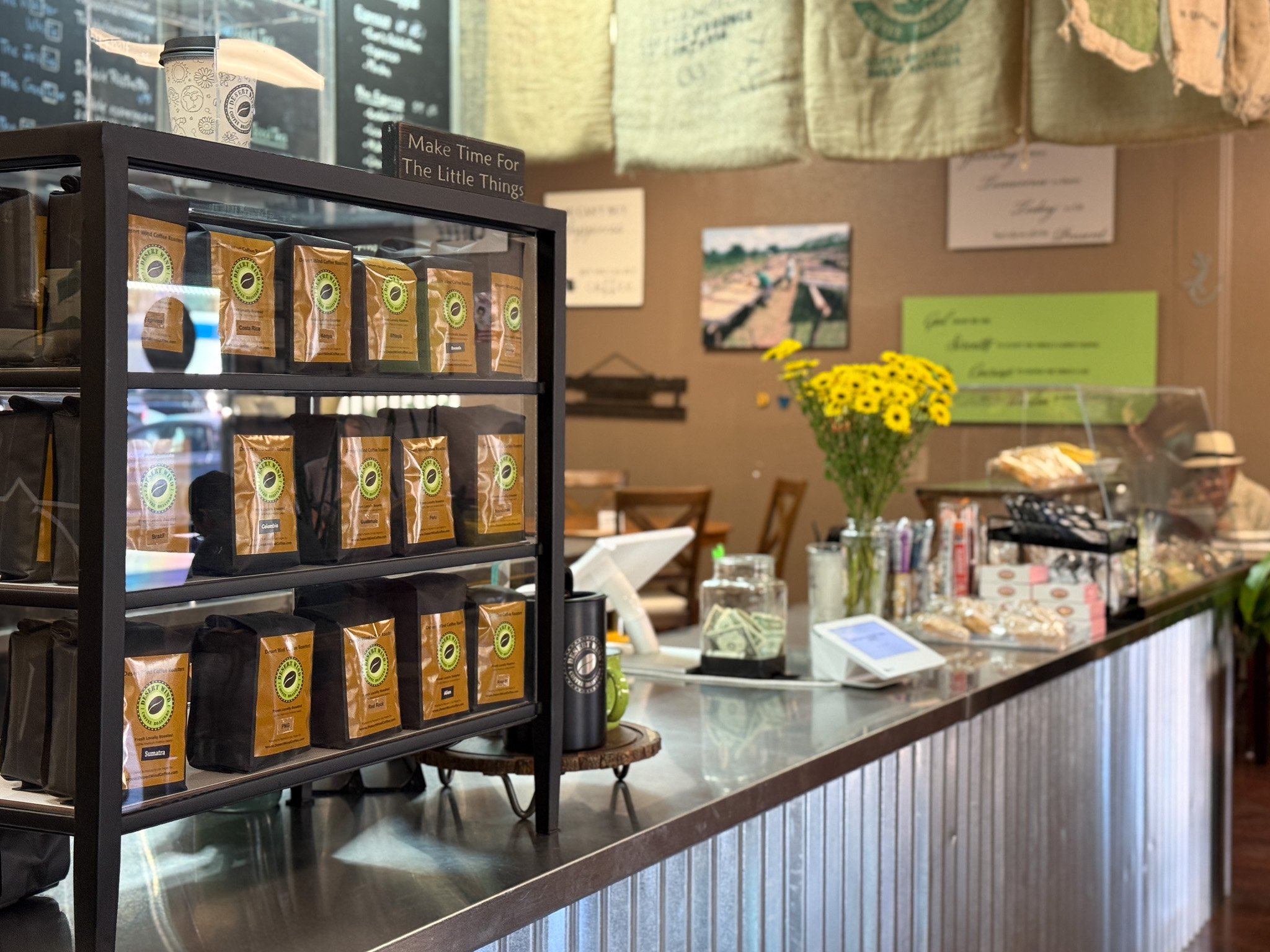 Fresh-roasted Desert Wind coffee bags on the counter display